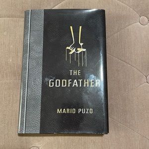 “The Godfather” by Mario Puzo hardcover book.